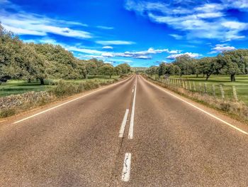 Empty road along countryside landscape