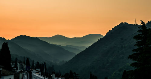 Panoramic view of silhouette mountains against sky during sunset