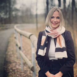 Portrait of smiling young woman standing outdoors