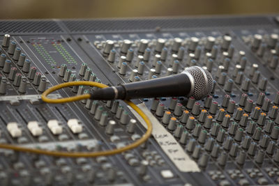 Close-up of microphone on sound mixer