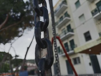 Low angle view of chain hanging on rope