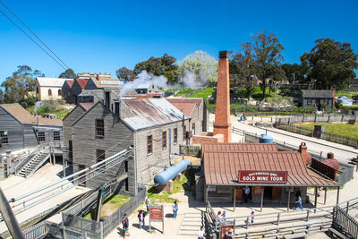 High angle view of buildings against blue sky