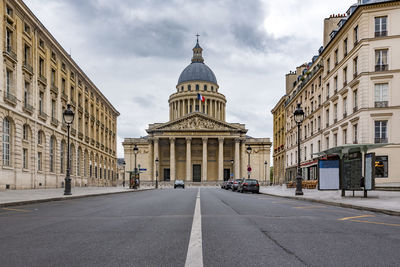 Street amidst buildings against sky in city