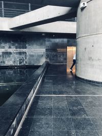 Side view of man walking in building