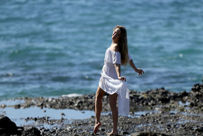 Portrait of woman standing on beach