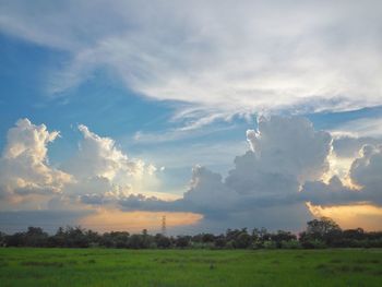 Scenic view of field against sky during sunset