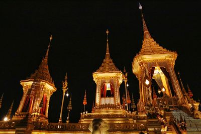 Low angle view of illuminated cathedral against sky at night