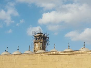 Low angle view of temple against cloudy sky