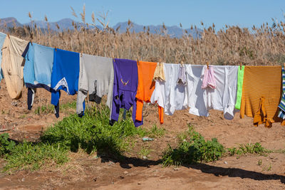 Panoramic shot of clothes drying on field against sky