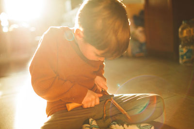 Rear view of boy playing