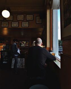 Rear view of people standing in restaurant