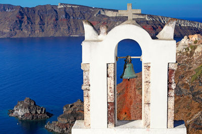 Panoramic view of sea and buildings against blue sky