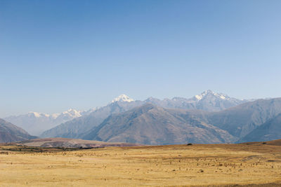 Scenic view of snowcapped mountains against clear blue sky