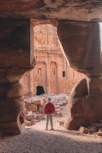 Rear view of man standing in tunnel