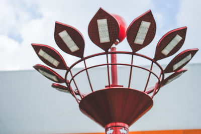 Low angle view of lamp lights against sky