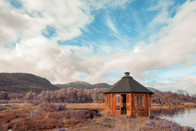 House on mountain against sky