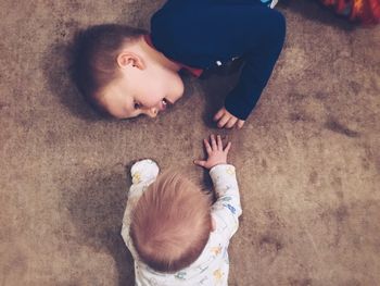 High angle view of sibling playing at home