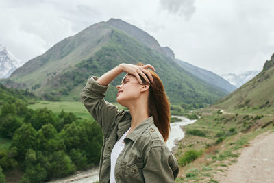 Rear view of woman standing on mountain