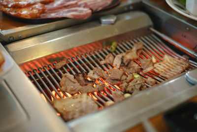 High angle view of meat on barbecue grill