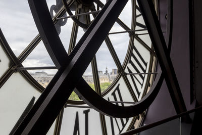 Famous clock with roman numerals round window in orsay museum,