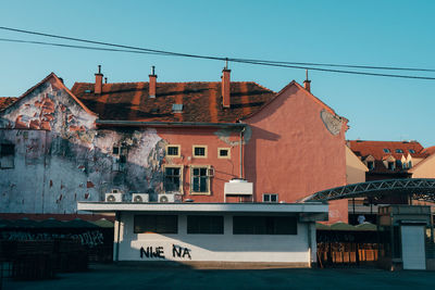 Buildings in town against clear blue sky