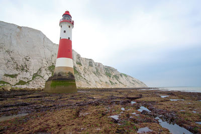 Beachy head lighthouse, seven sisters chalk cliffs at low tide near eastbourne, east sussex