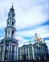 Low angle view of bell tower against cloudy sky