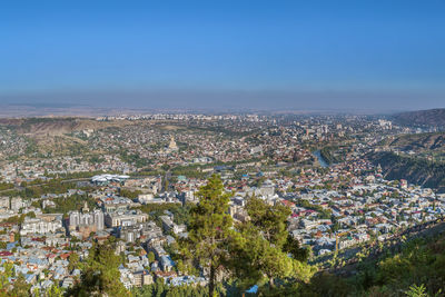 High angle shot of townscape against blue sky