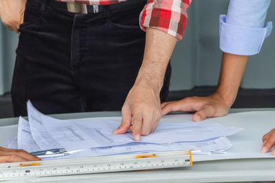 Midsection of man working on table