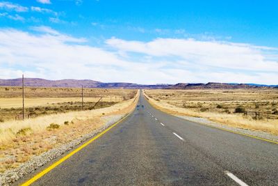 Empty road along countryside landscape