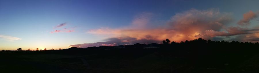 Panoramic view of silhouette landscape against sky during sunset