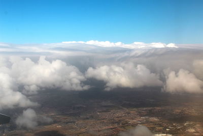 Aerial view of clouds over landscape against sky