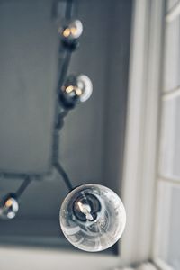 Close-up of illuminated light bulb at home