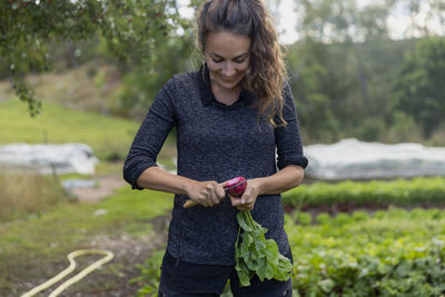 Smiling woman cutting beetroot