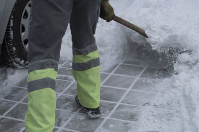 Low section of man standing on snow