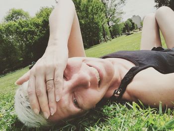 Close-up of woman lying on field