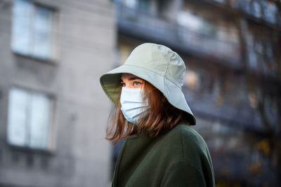 Portrait of woman wearing hat standing outdoors