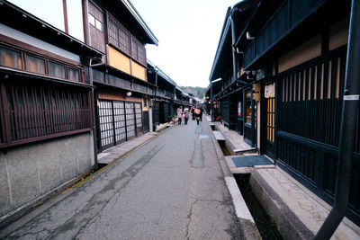 Street amidst buildings against sky in city