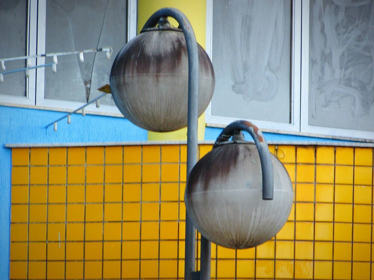 CLOSE-UP OF ELECTRIC LAMP HANGING AGAINST WALL