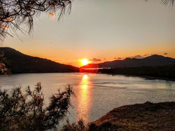 Scenic view of lake against sky during sunset