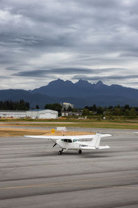 Airplane on runway against sky