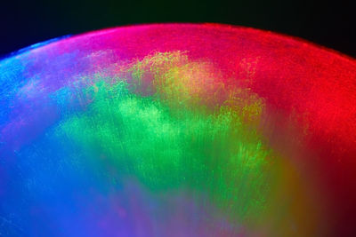 Close-up of rainbow over black background