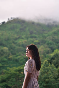 Side view of a young woman looking away