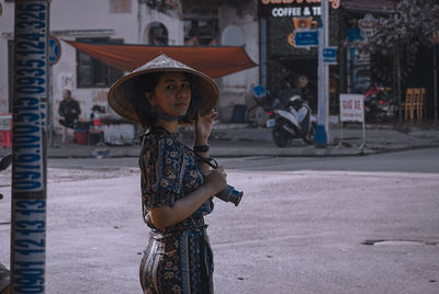 Full length portrait of woman standing in city