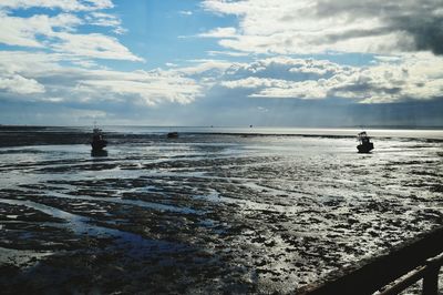 Silhouette man in sea against sky