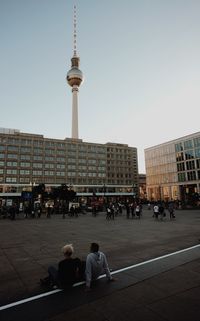 People in city against clear sky