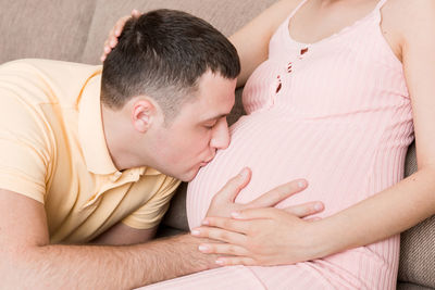 Midsection of couple kissing