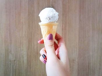 Cropped image of hand holding ice cream cone