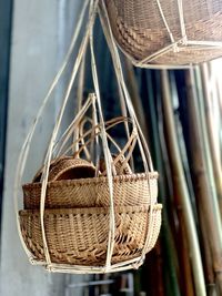 Close-up of wicker baskets hanging indoors
