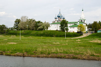 View of temple by building against sky